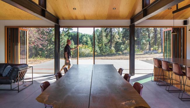 Expansive Centoe bifold doors with built in fly screen