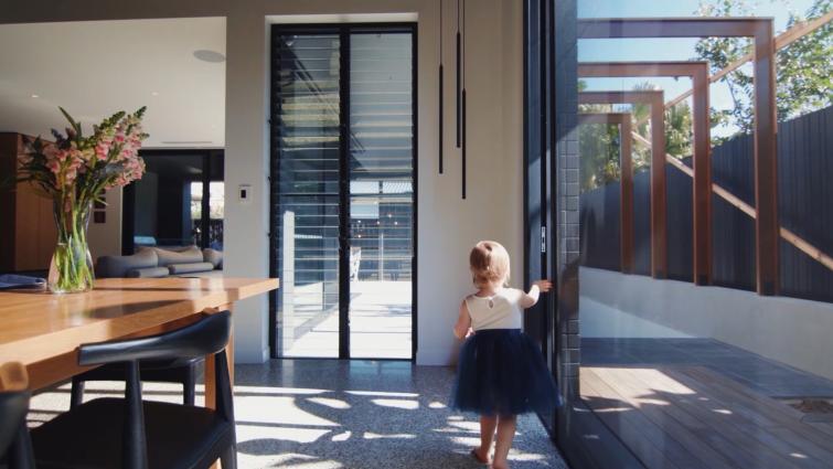 a small girl closes the insect screen